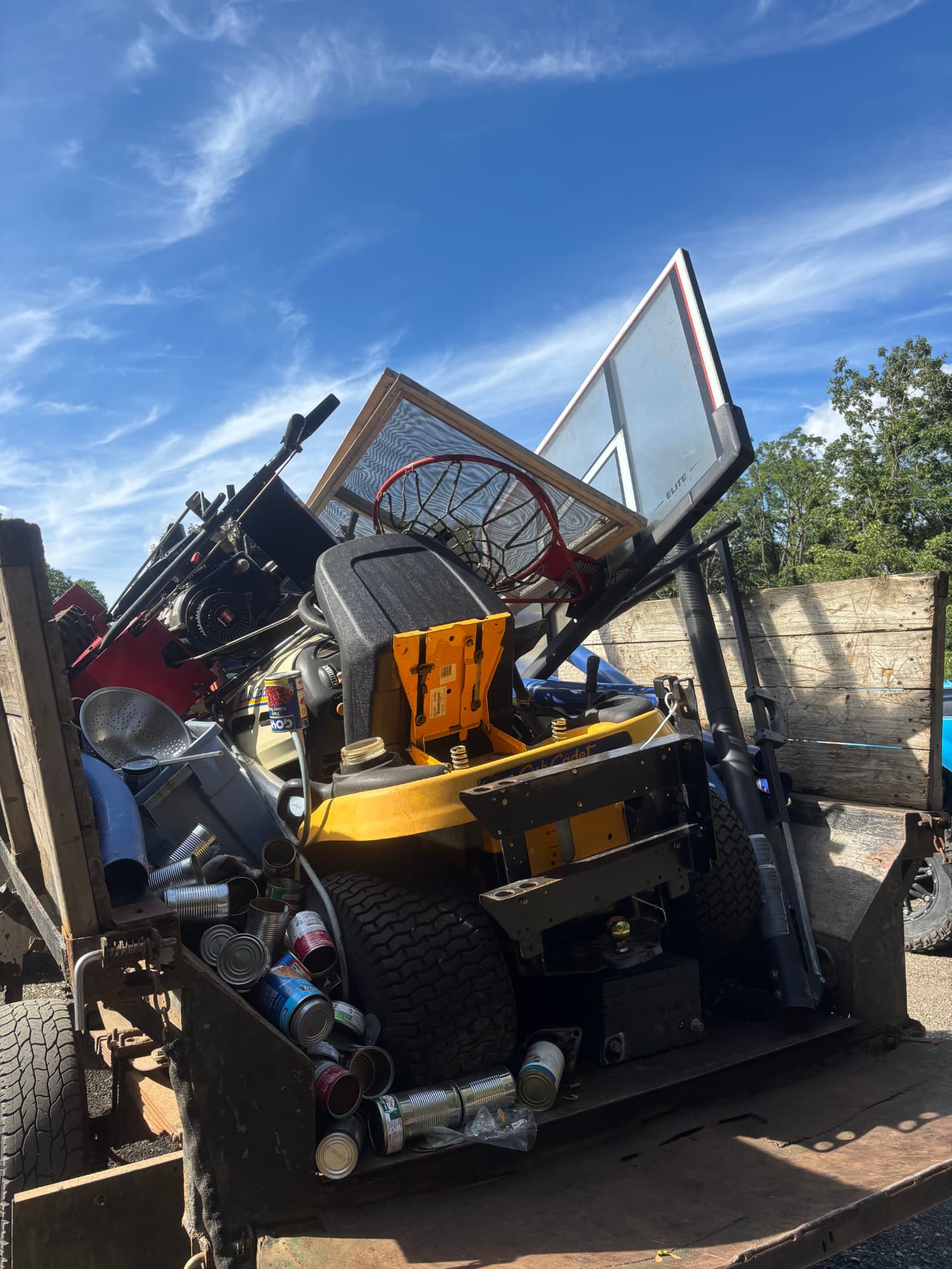 MWI Recycling trailer loaded with junk, appliances, and scrap ready for removal